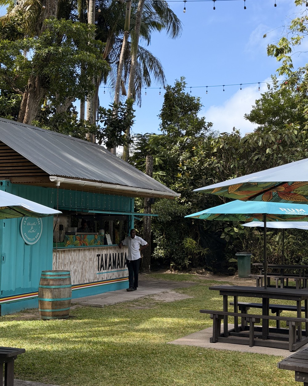 Ellen walking through the tropical gardens at Takamaka Rum Distillery on Mahe