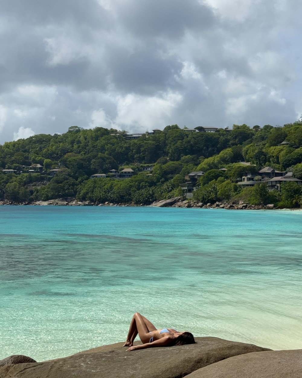 Turquoise water and green hills at Petite Anse on Mahe