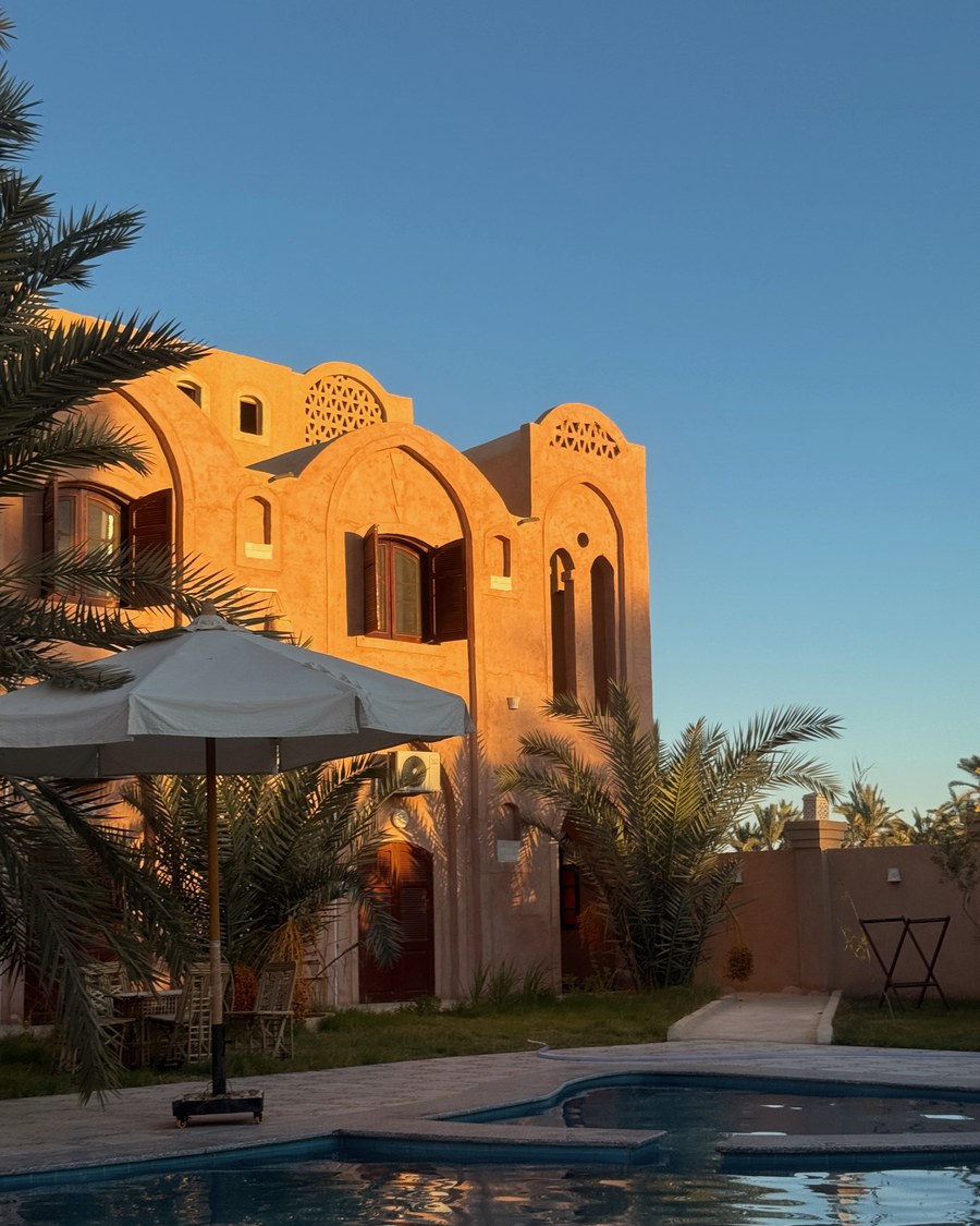 Hotel Talid and its pool in Siwa Oasis at sunset