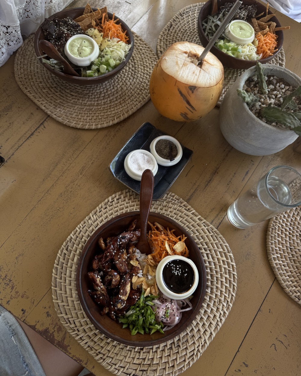 Poke bowl on a wooden table at Malu Poke in Hiriketiya, Sri Lanka