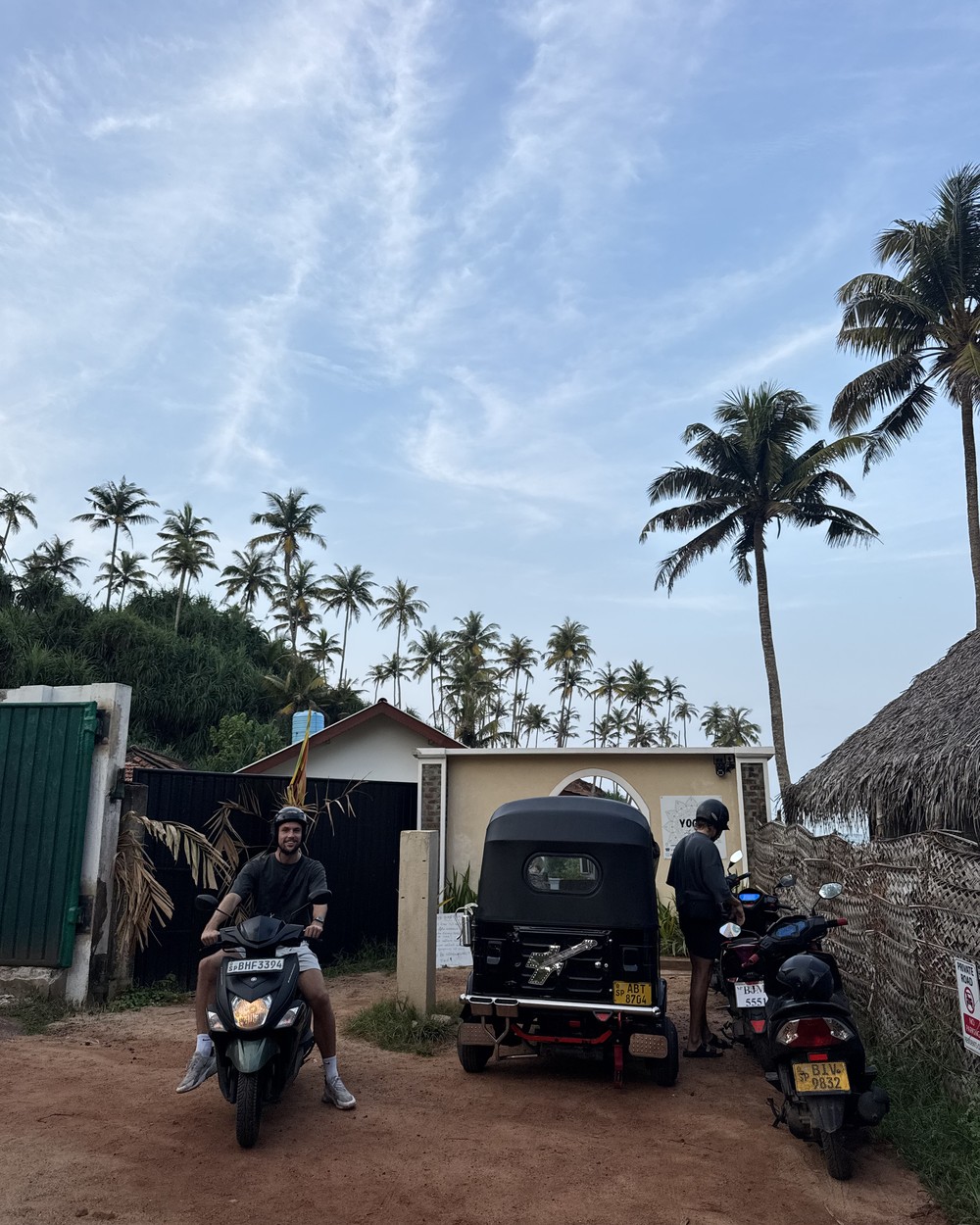 Scooters parked in a row on a street in Mirissa, Sri Lanka