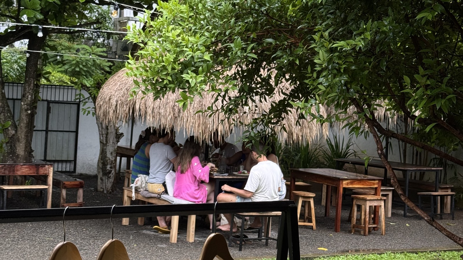 Thatched cafe with tables and garden seating at Moochies in Weligama, Sri Lanka