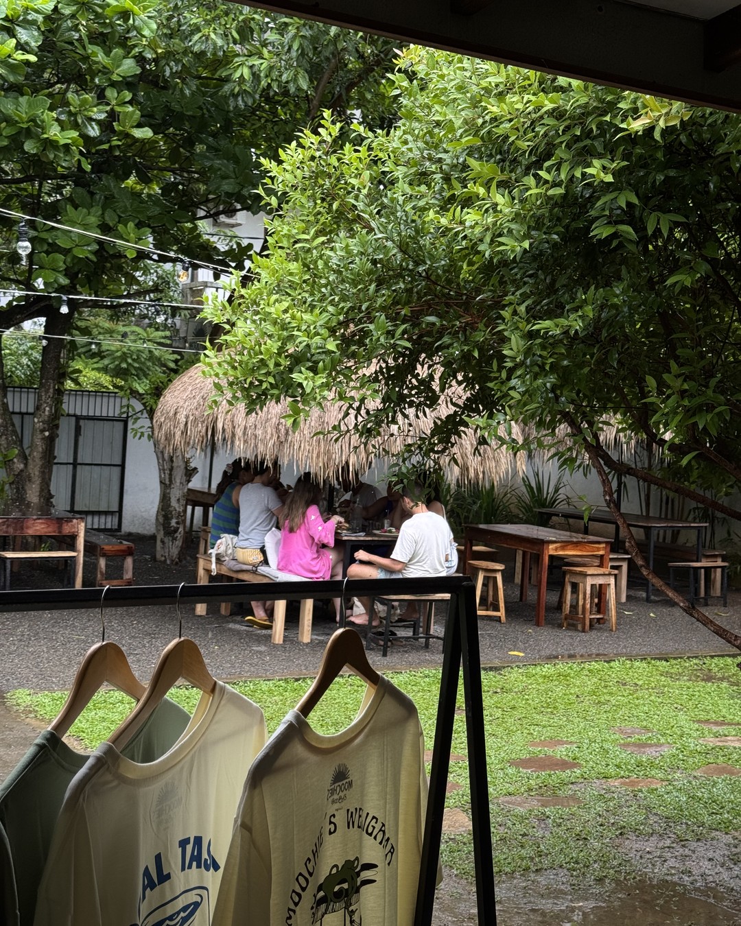 Thatched cafe with tables and garden seating at Moochies in Weligama, Sri Lanka