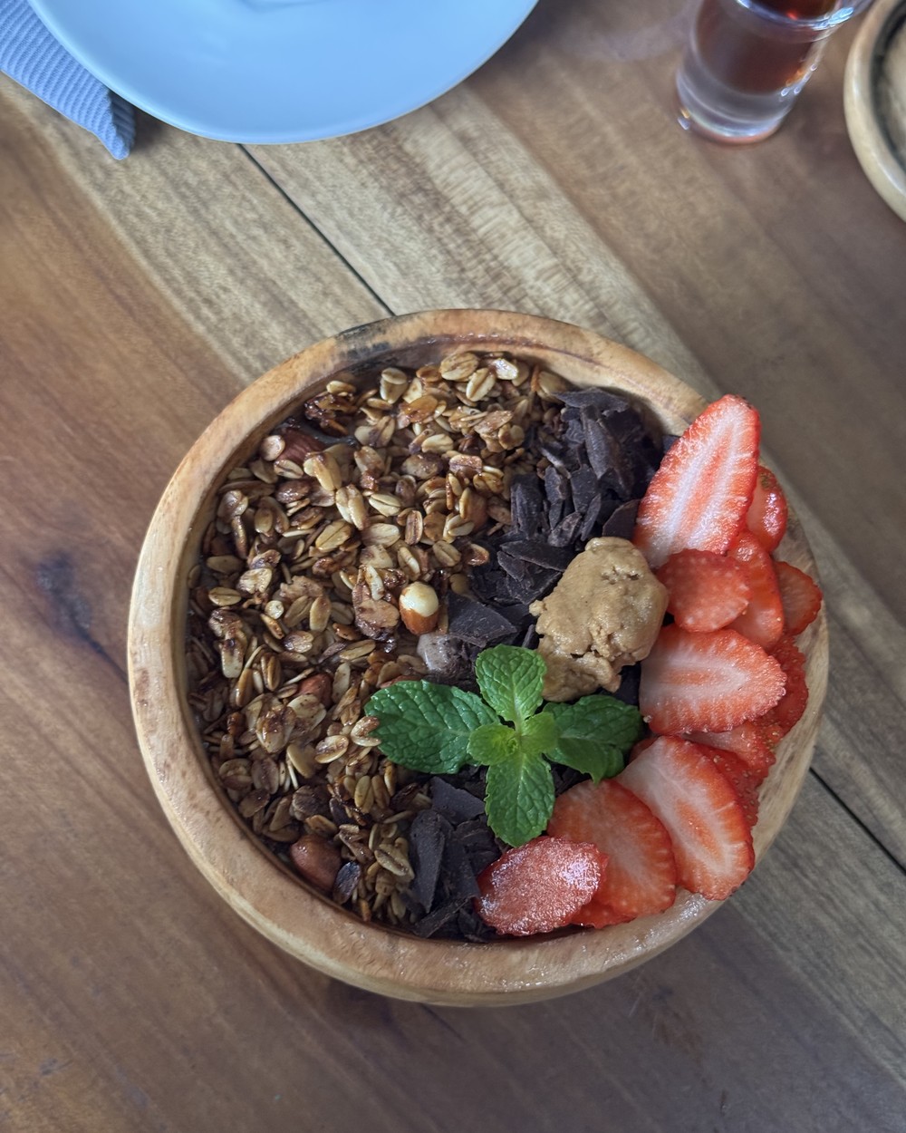 Smoothie bowl topped with granola, strawberries and mint at Moochies in Weligama, Sri Lanka