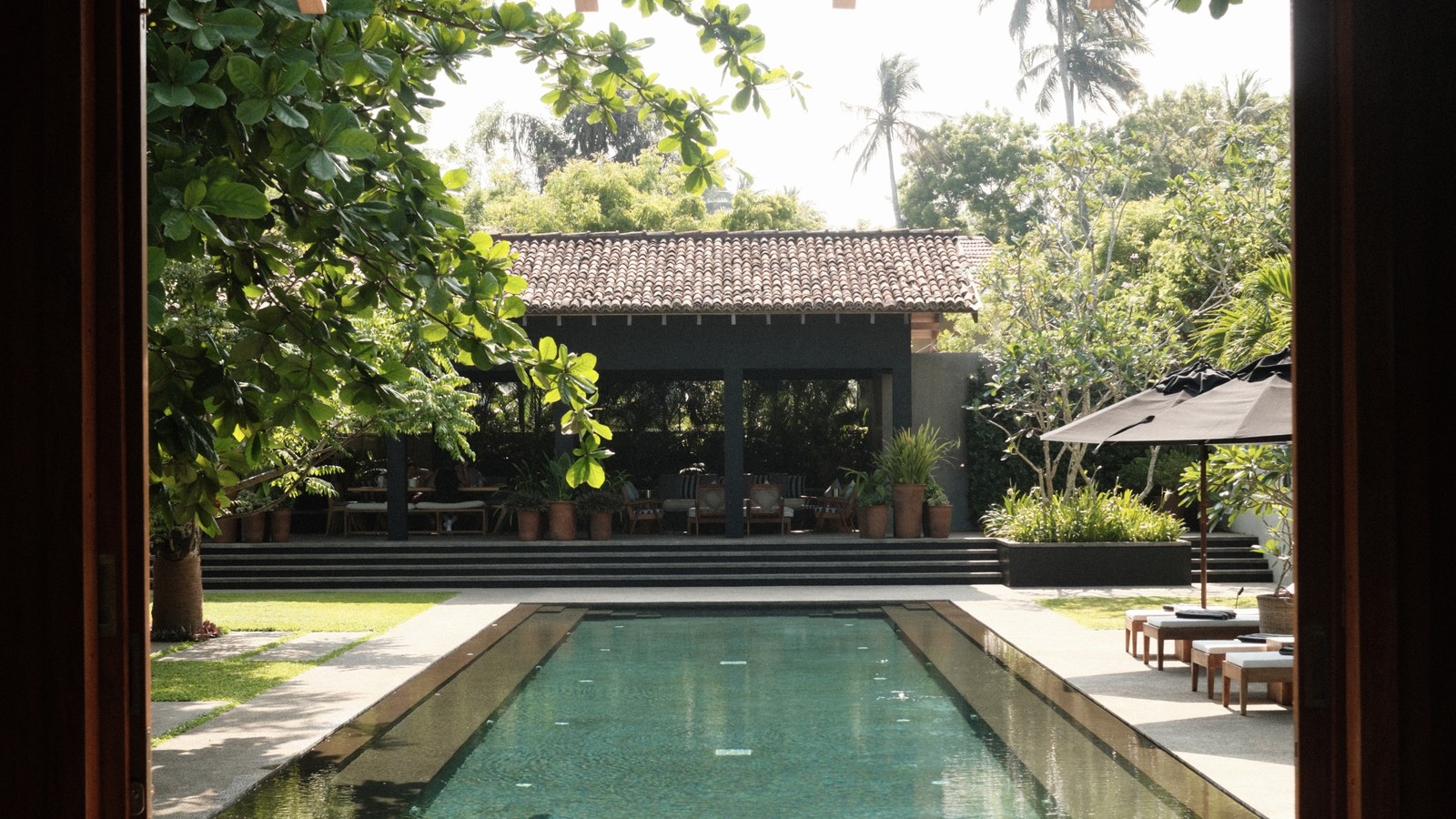 Long lap pool seen through an open pavilion at a villa near Tangalle, Sri Lanka