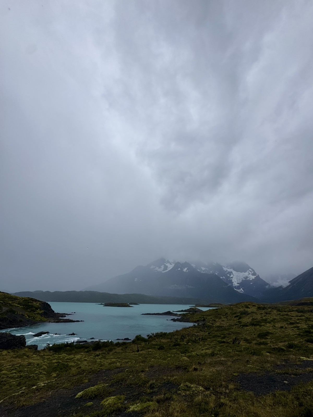 The landscape of Torres del Paine National Park beneath a cloudy sky