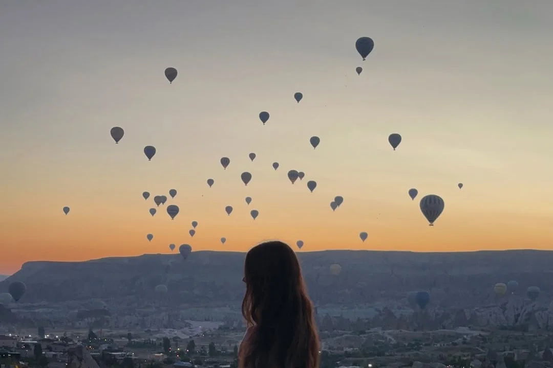 Watching the hot air balloons rise over Cappadocia at sunrise, Türkiye