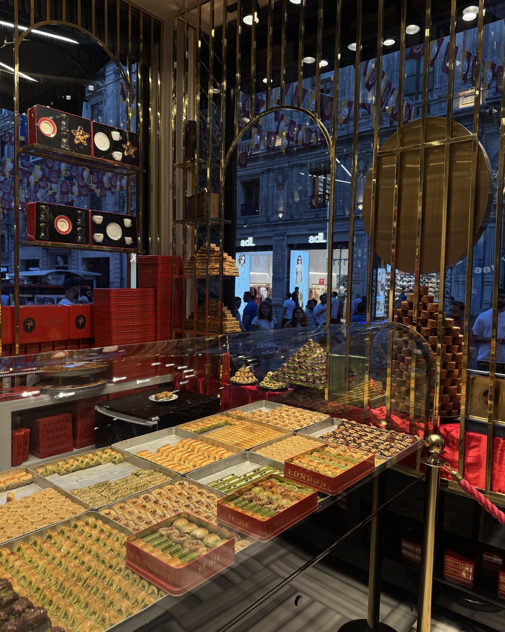 Trays of baklava in a gold-lit shop window in Istanbul