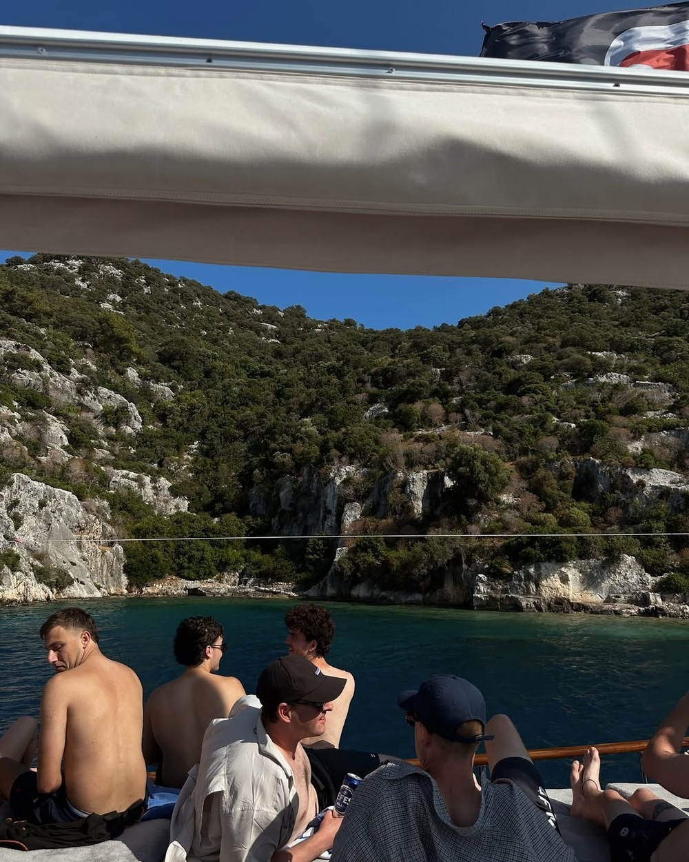 People relaxing on the deck of a traditional wooden gulet boat on the Turkish Riviera