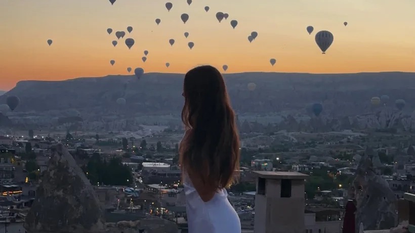 Ellen watching hot air balloons over Cappadocia on our Turkey itinerary