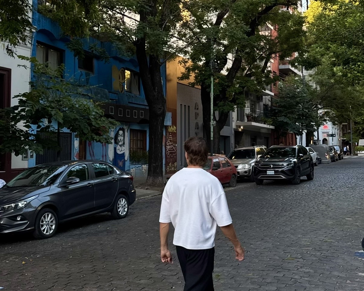 Daniel walking along a cobbled street in Palermo Soho, Buenos Aires