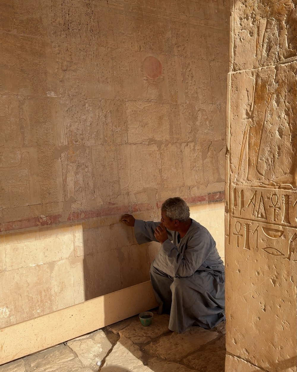 Sunlit carved walls inside the Temple of Hatshepsut in Luxor