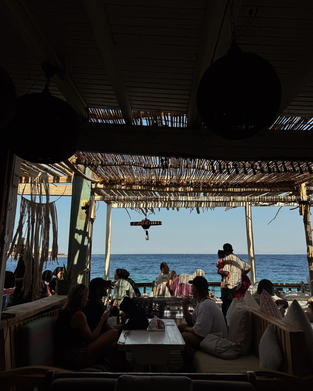Dahab waterfront restaurants glowing at sunset beside the Red Sea