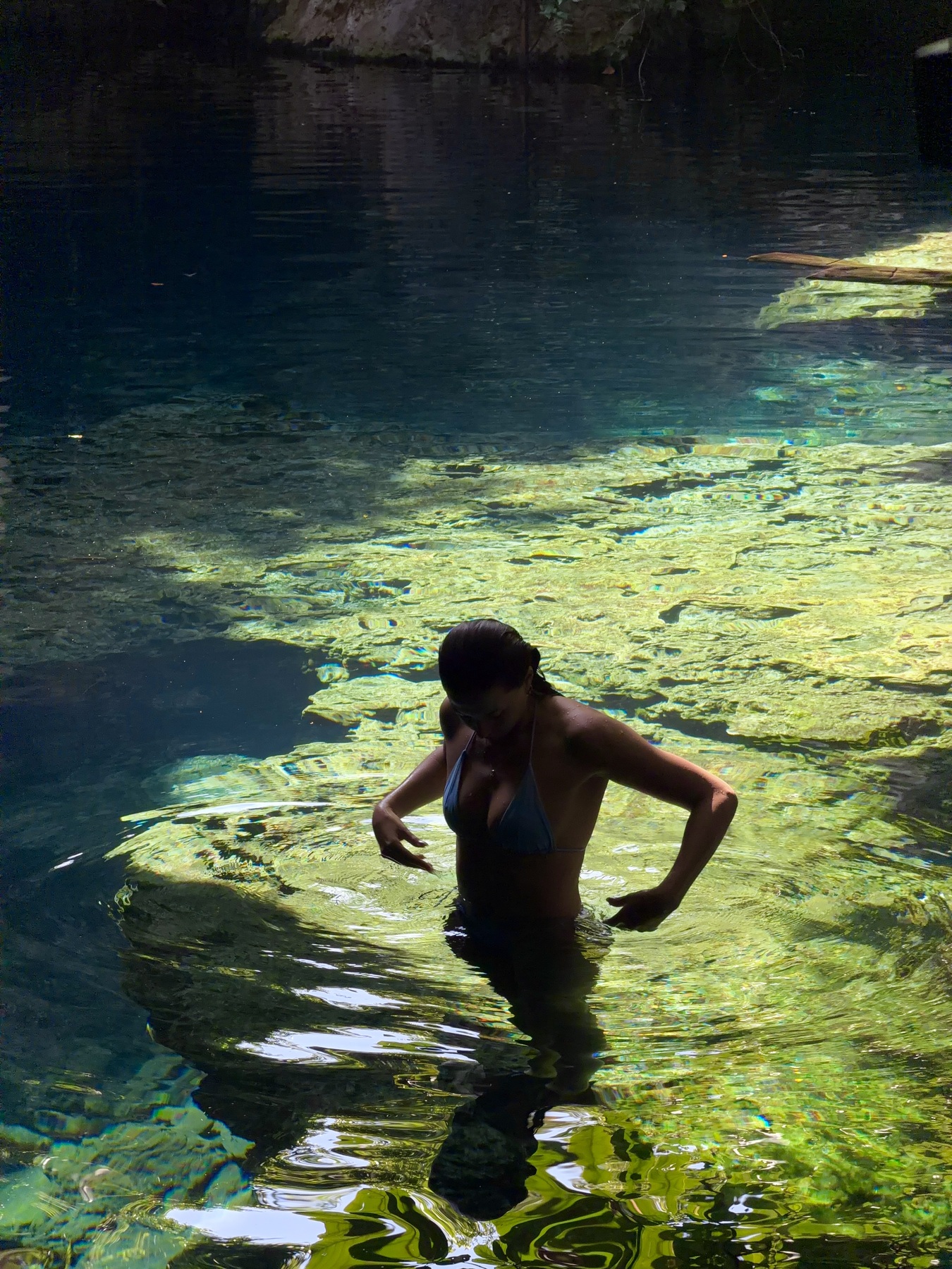 Ellen standing in the sunlit shallows of Maalum's natural swimming pool