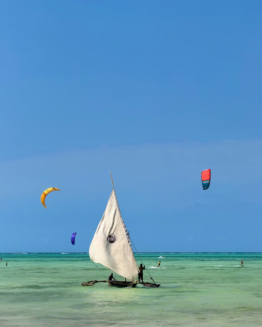 Kite surfers on the shallow turquoise lagoon at Paje beach in Zanzibar