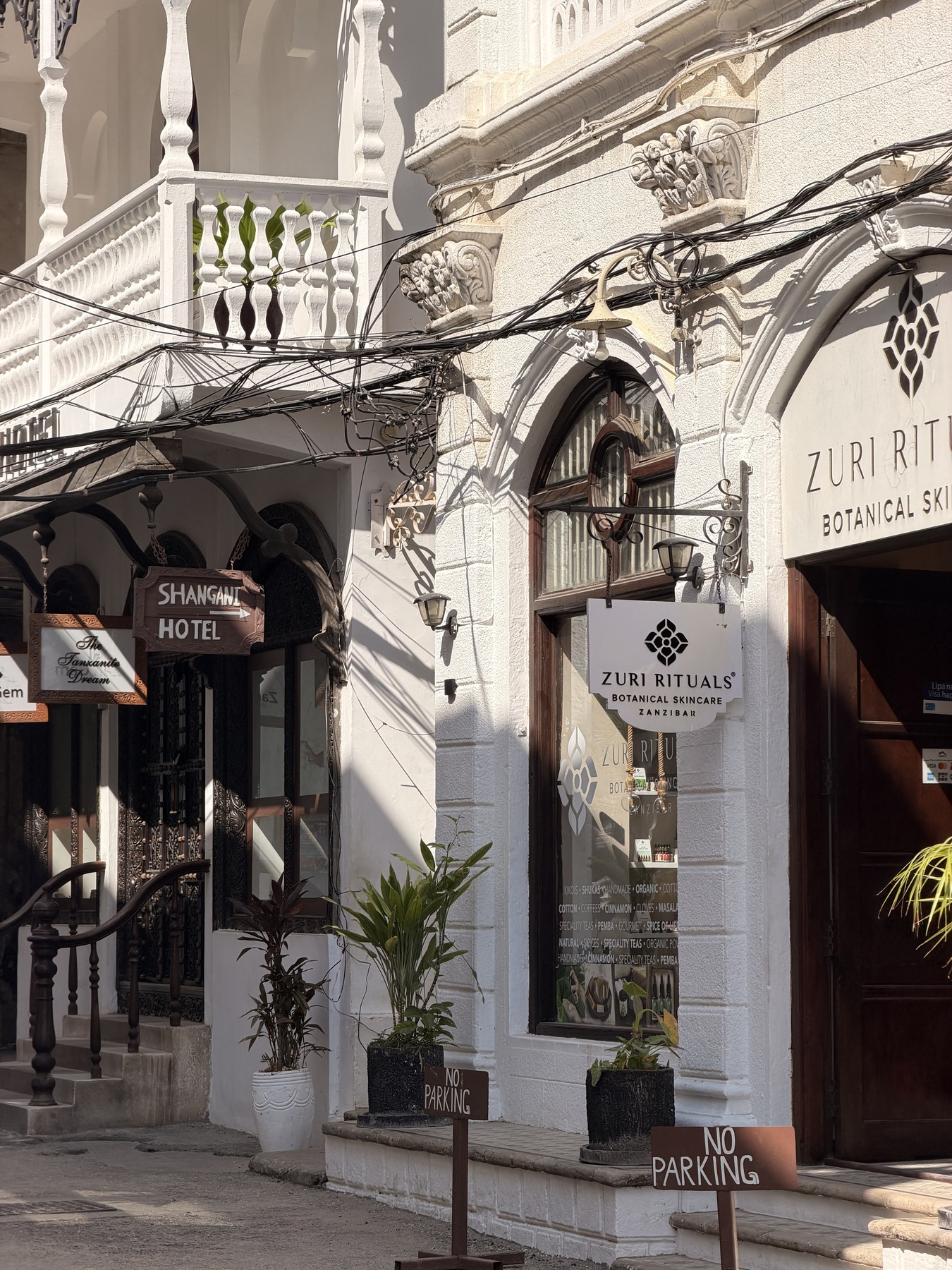 Carved doorways, balconies and shopfronts along a Stone Town street