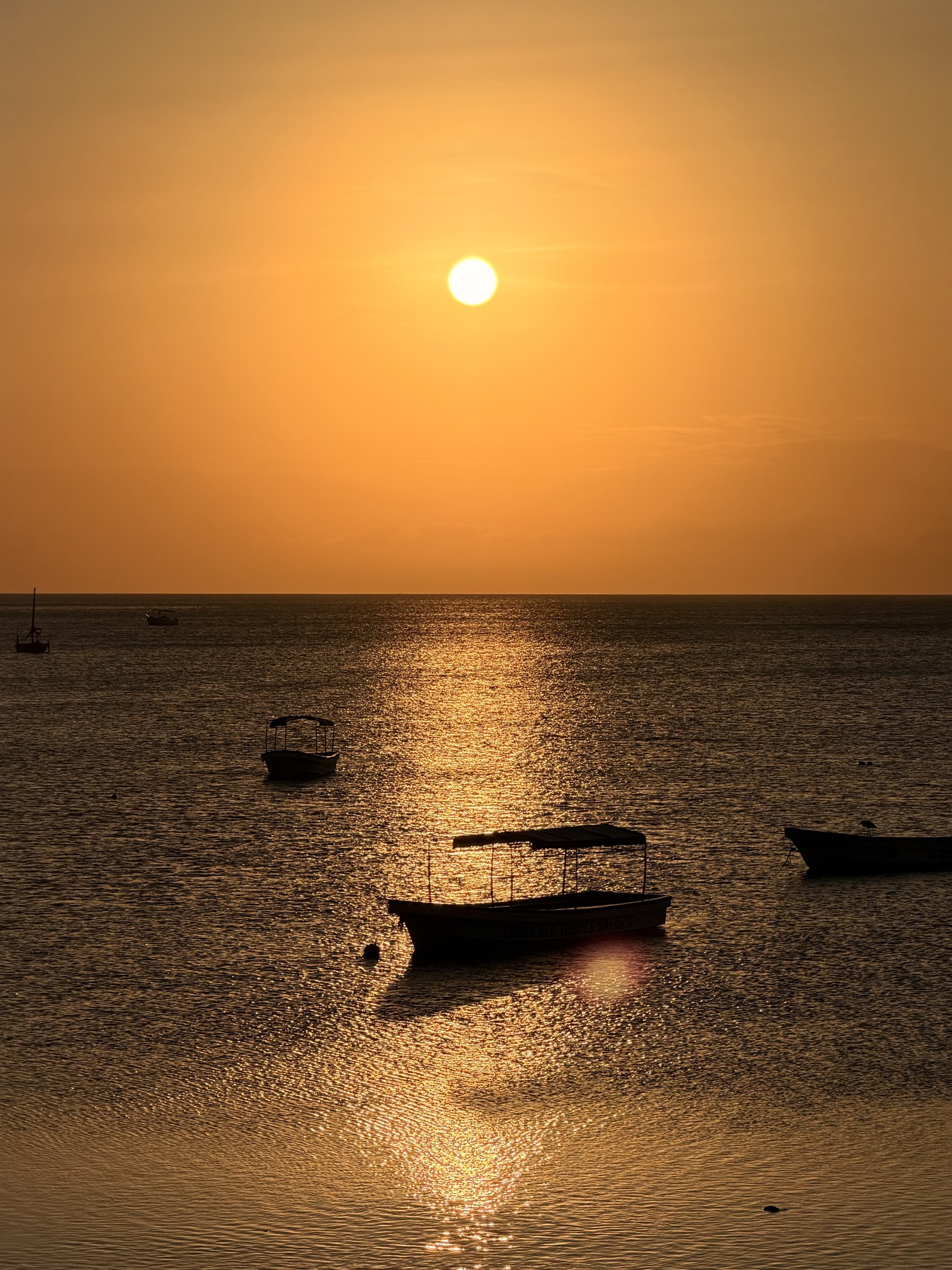 Sunset over boats and the sea off Nungwi, photographed from Maisha