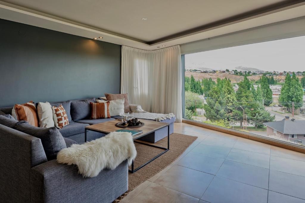Lounge with a big window at Montano Boutique Suites in El Calafate